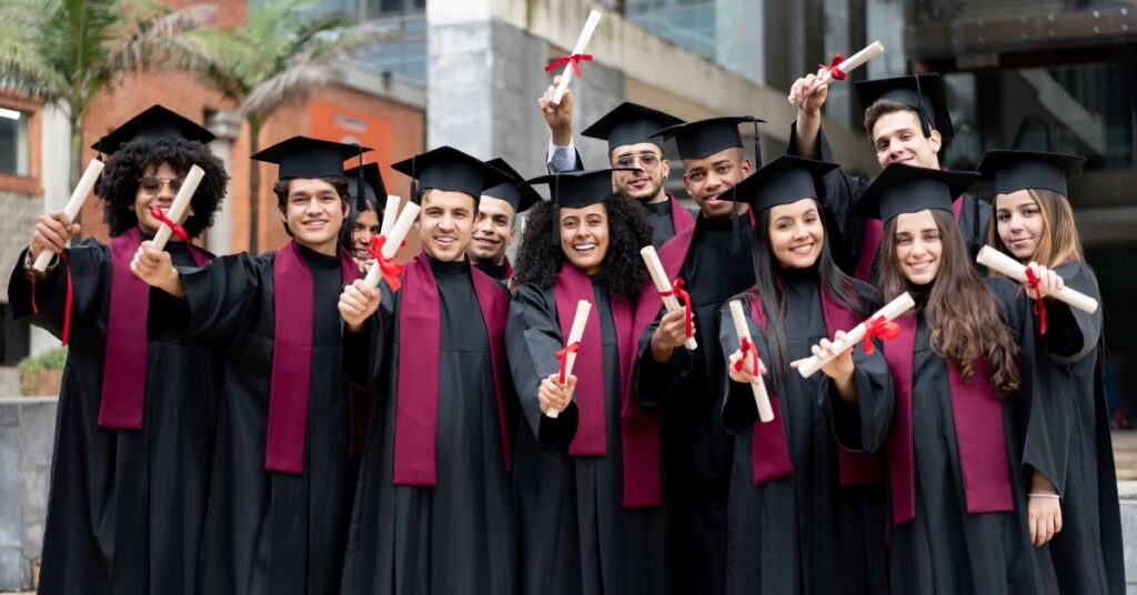 `UK university graduates holding diplomas after completing their fully funded degrees`