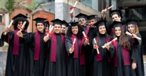 `UK university graduates holding diplomas after completing their fully funded degrees`