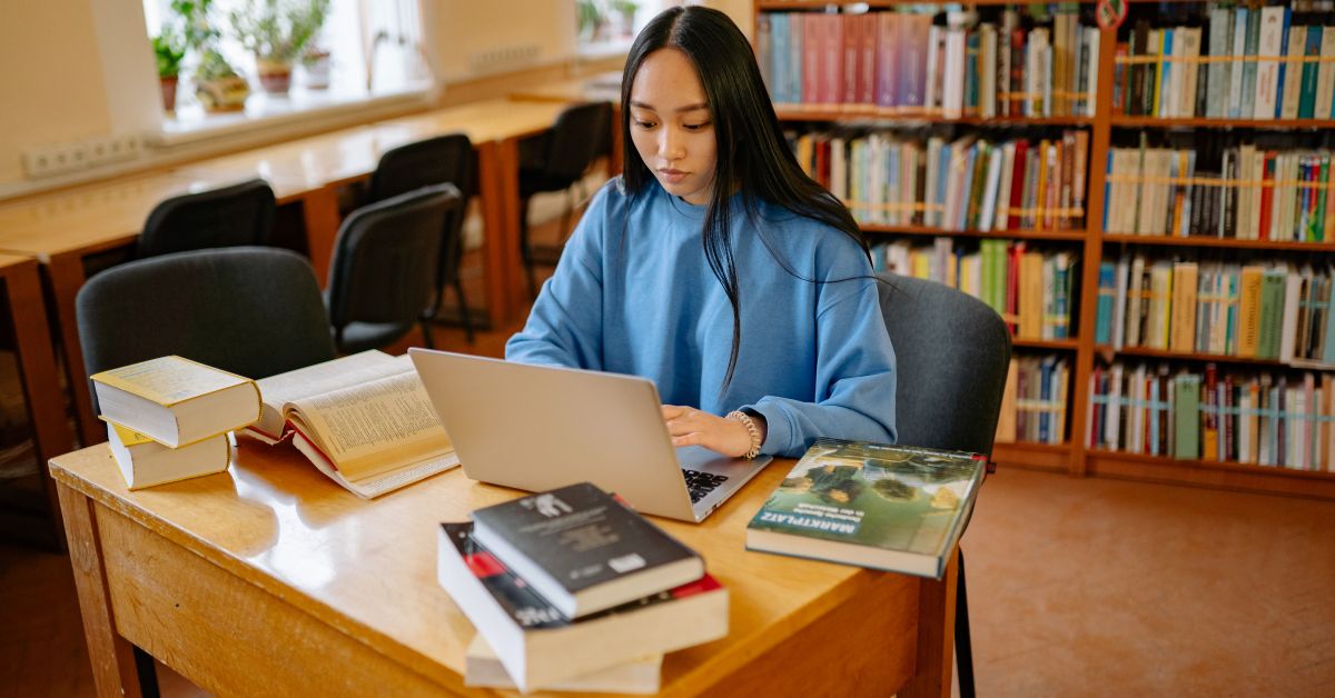 `UK student finance application being researched on a laptop in a university library`