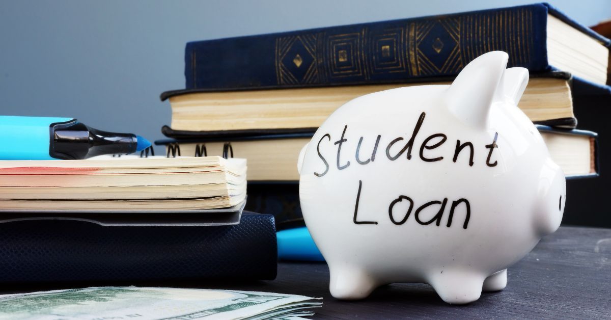 `Piggy bank labelled Student Loan next to university books representing UK tuition fee and maintenance loan options`