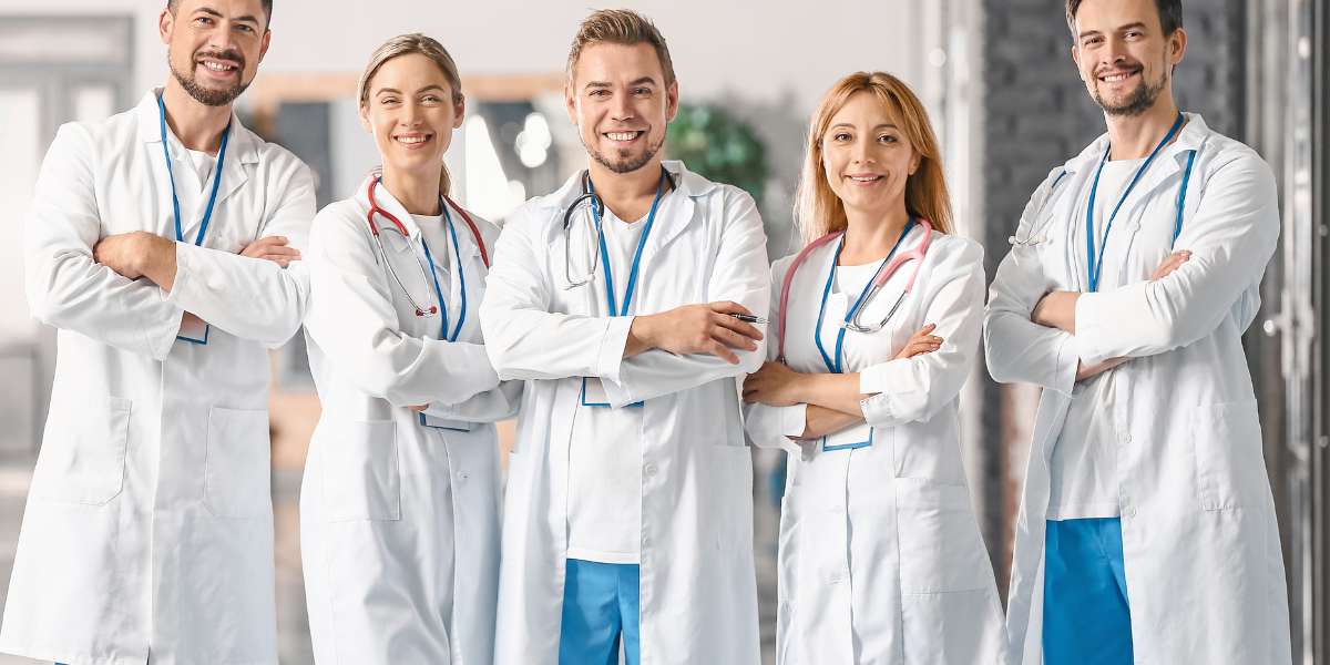 A team of healthcare and social care professionals smiling in a clinic setting, showcasing potential high-paying career paths and graduate salaries.
